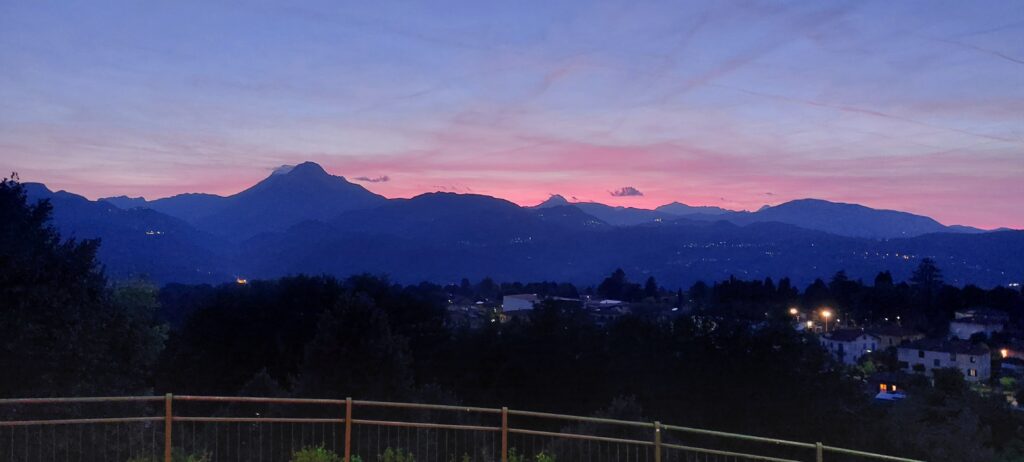 Autumn sunset over the mountains seen from a bedroom window at Art Toscana, Tuscany